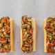 Overhead view of 3 of Buona's plant-based Italian Beefless Sandwiches